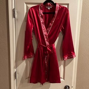 Red robe with heart trim decor and pockets, size S/M New without tags